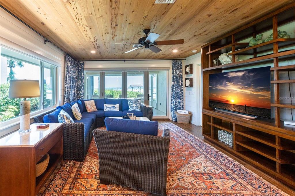 6020 Midnight Pass Road, Unit 26 Sarasota, FL 34242 - Photo 5 of 25 a living room with furniture and a flat screen tv