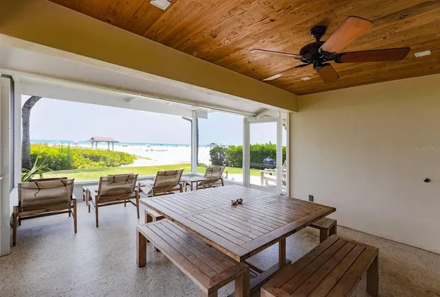 a view of a patio with a table chairs and a backyard