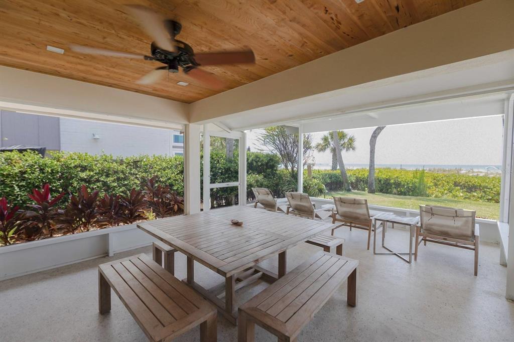6020 Midnight Pass Road, Unit 26 Sarasota, FL 34242 - Photo 7 of 25 a view of a patio with a table chairs and a backyard