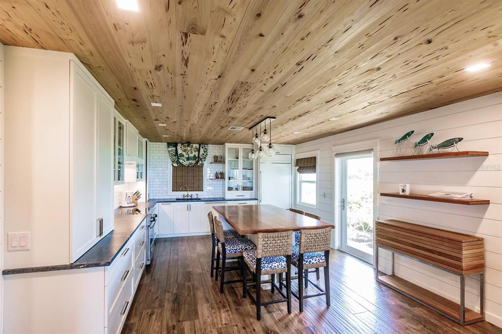 6020 Midnight Pass Road, Unit 26 Sarasota, FL 34242 - Photo 10 of 25 a dining room with furniture and wooden floor