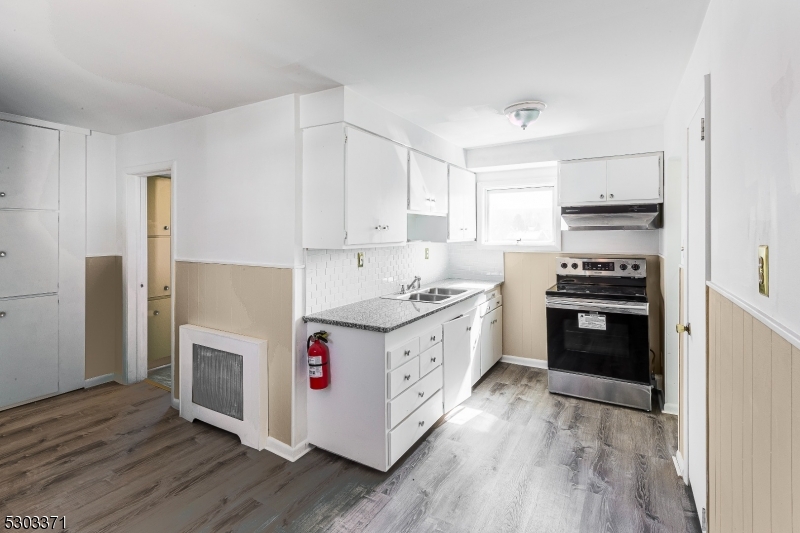 26 Schooleys Mountain Road Long Valley, NJ 07853 - Photo 2 of 10 a kitchen with granite countertop a stove top oven and cabinets