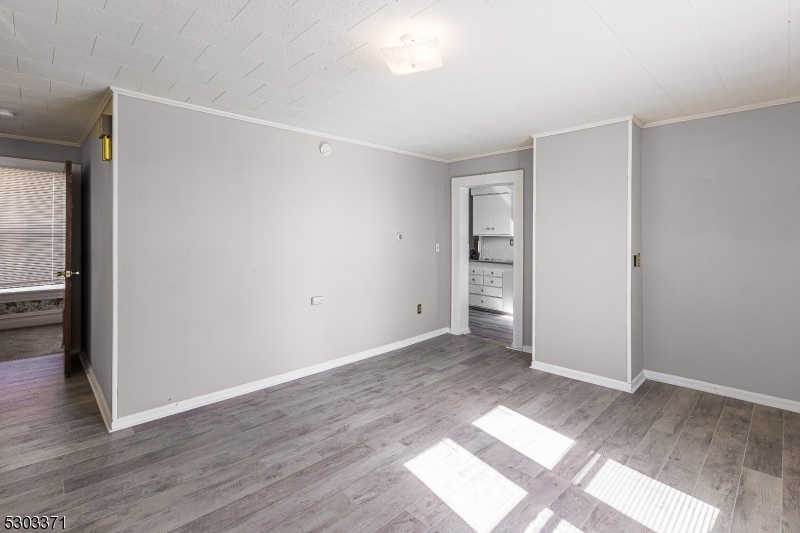 26 Schooleys Mountain Road Long Valley, NJ 07853 - Photo 4 of 10 a view of an empty room with wooden floor and a window