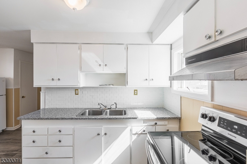 26 Schooleys Mountain Road Long Valley, NJ 07853 - Photo 6 of 10 a kitchen with granite countertop a sink stove and cabinets