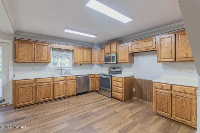 a kitchen with wooden floors and white appliances