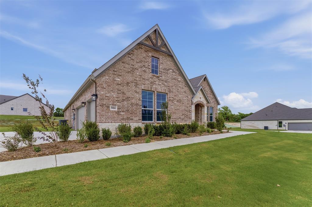 906 Perrin Lane Van Alstyne, TX 75495 - Photo 2 of 30 a front view of a house with a yard and garage