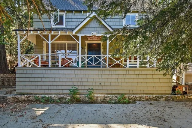 a view of a house with a small yard and potted plants