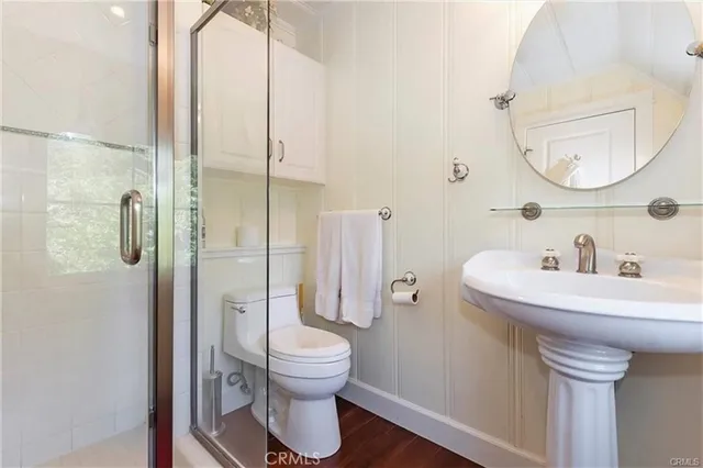 a bathroom with a toilet a sink and a mirror