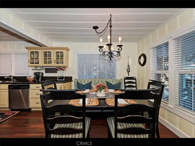 a view of a dining room with furniture and chandelier