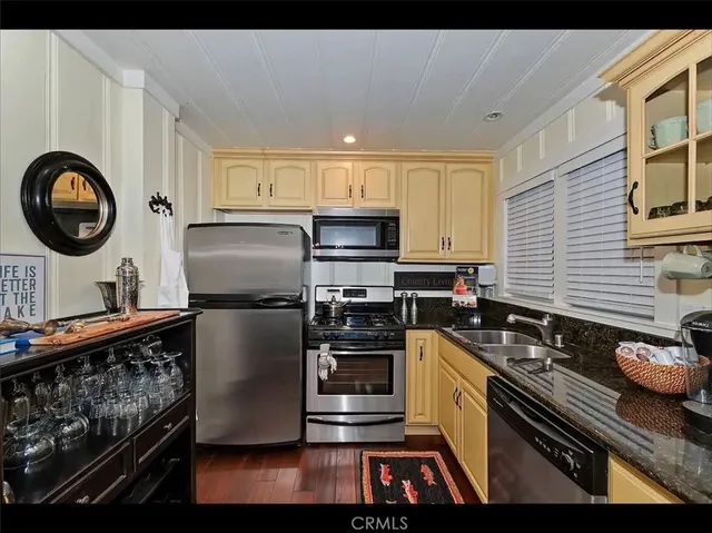 a kitchen with kitchen island granite countertop a stove and a sink