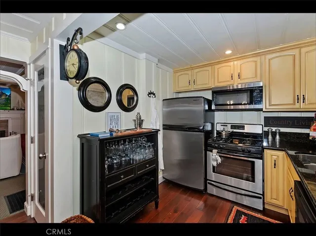 a kitchen with stainless steel appliances granite countertop a stove and a refrigerator
