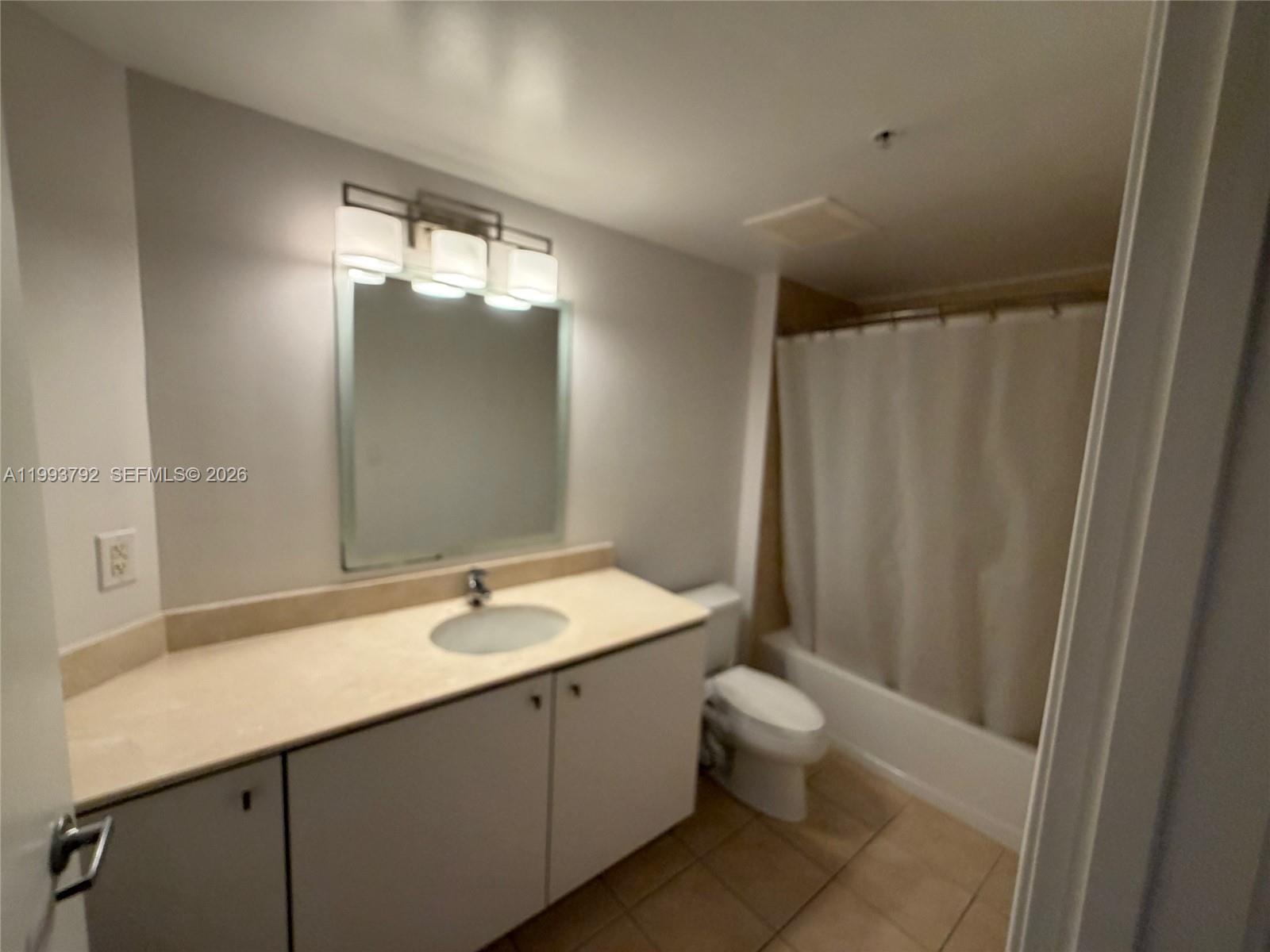 9055 Southwest 73rd Court, Unit 2002 Miami, FL 33156 - Photo 3 of 6 a bathroom with a sink toilet and shower
