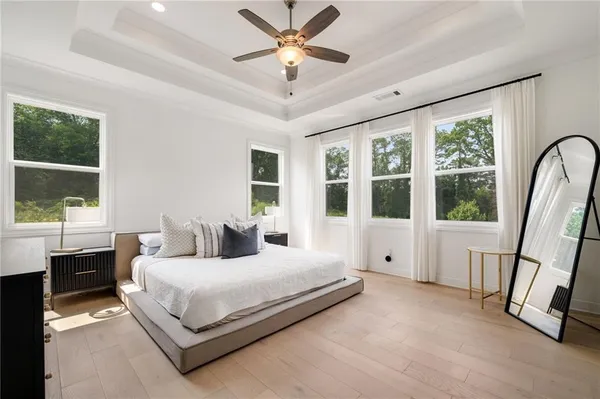 a bedroom with a large bed and a large window