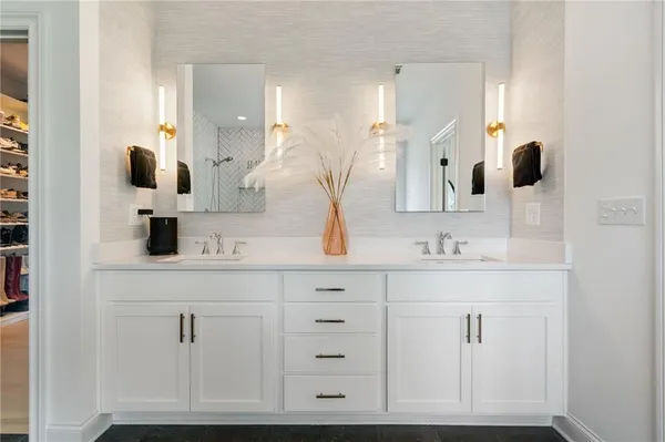 a bathroom with a sink vanity and mirror