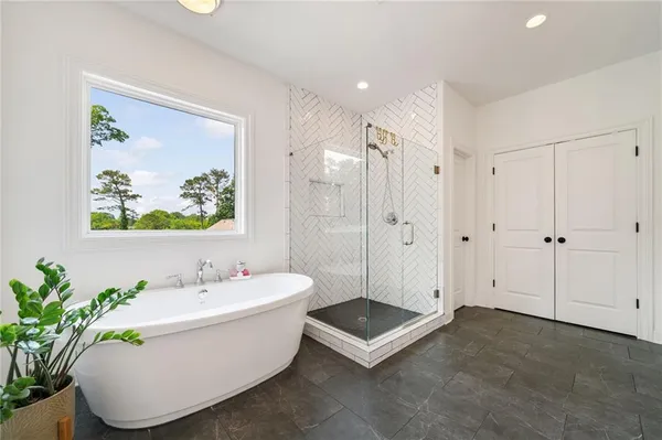 a bathroom with a bathtub a sink and a mirror