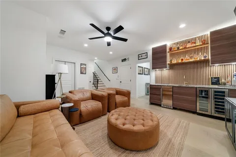 a living room with furniture and kitchen