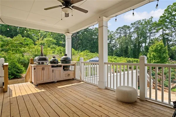a view of a roof deck with couches and wooden floor