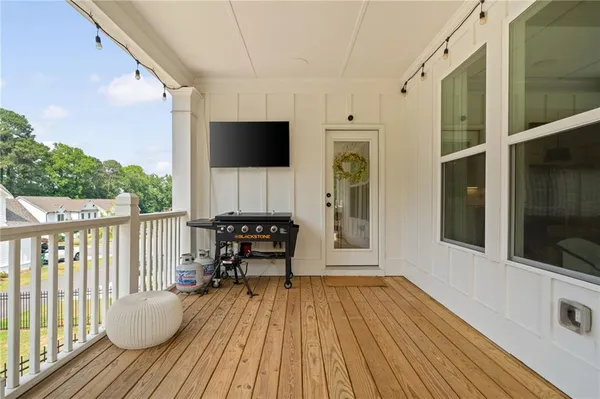 a view of a balcony with furniture and wooden floor