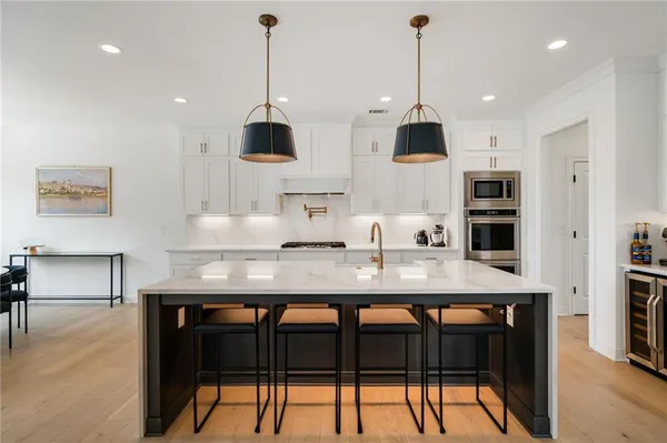 a kitchen with stainless steel appliances granite countertop a stove a sink and a refrigerator