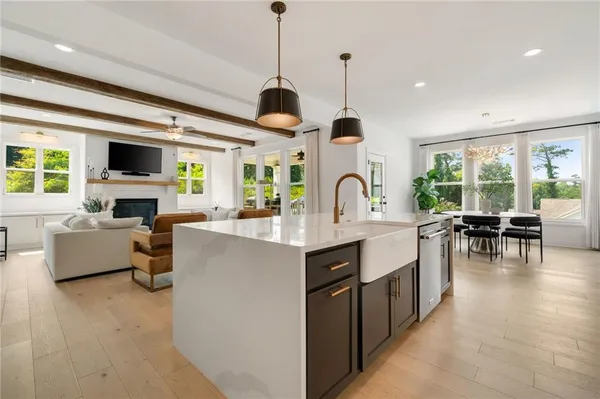 a kitchen with stainless steel appliances granite countertop sink stove and living room