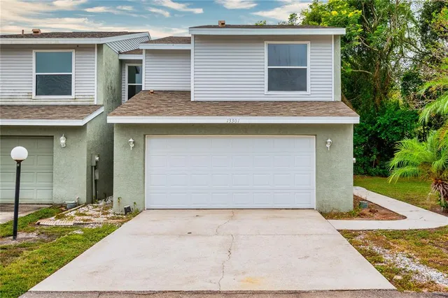 a front view of a house with a yard and garage