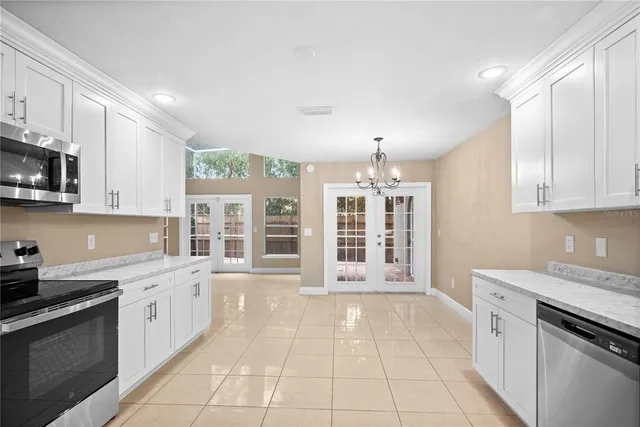 a kitchen with stainless steel appliances granite countertop a stove and a sink