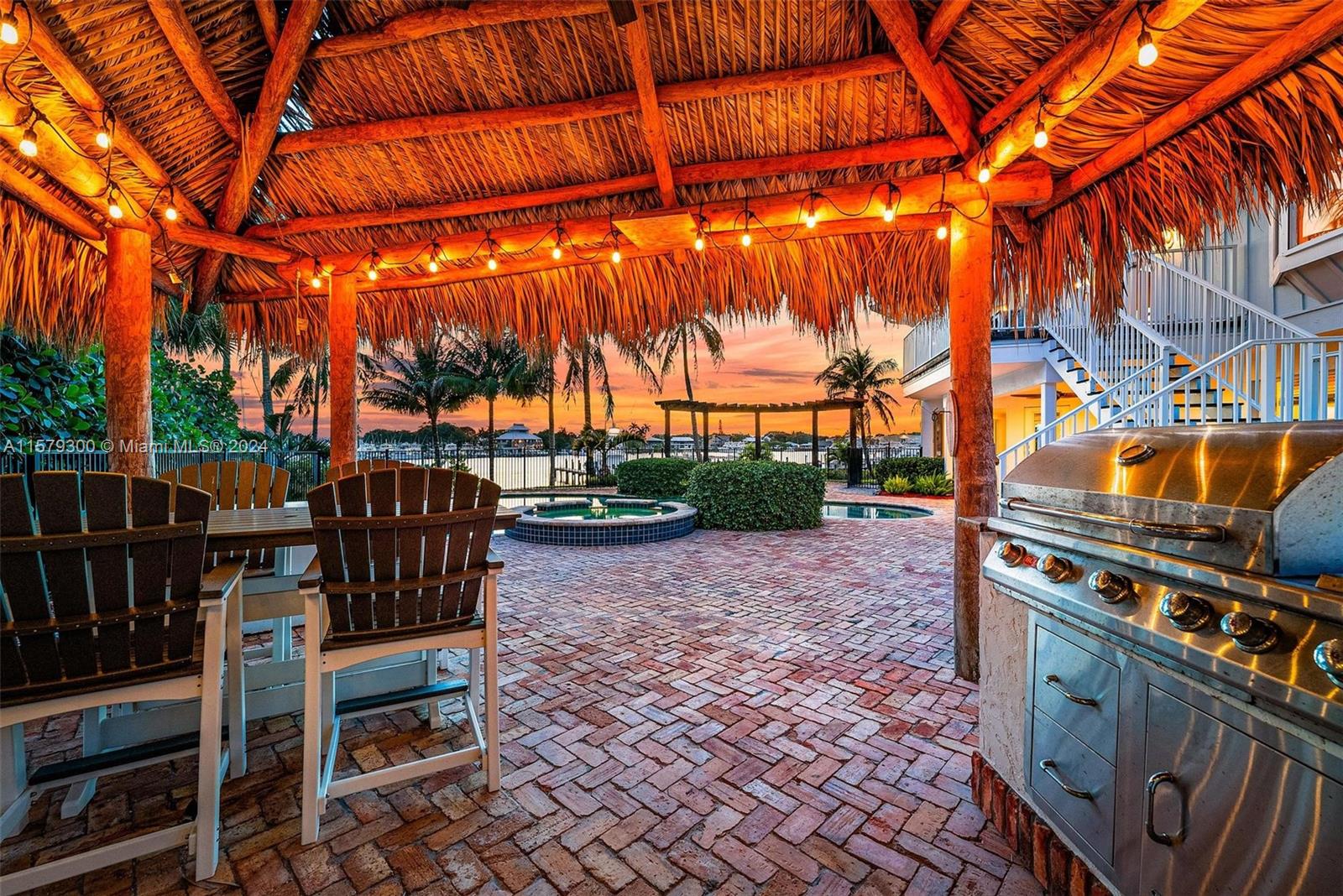 4643 Cheerio Way Stuart, FL 34997 - Photo 11 of 69 a view of a patio with table and chairs with wooden floor and fence
