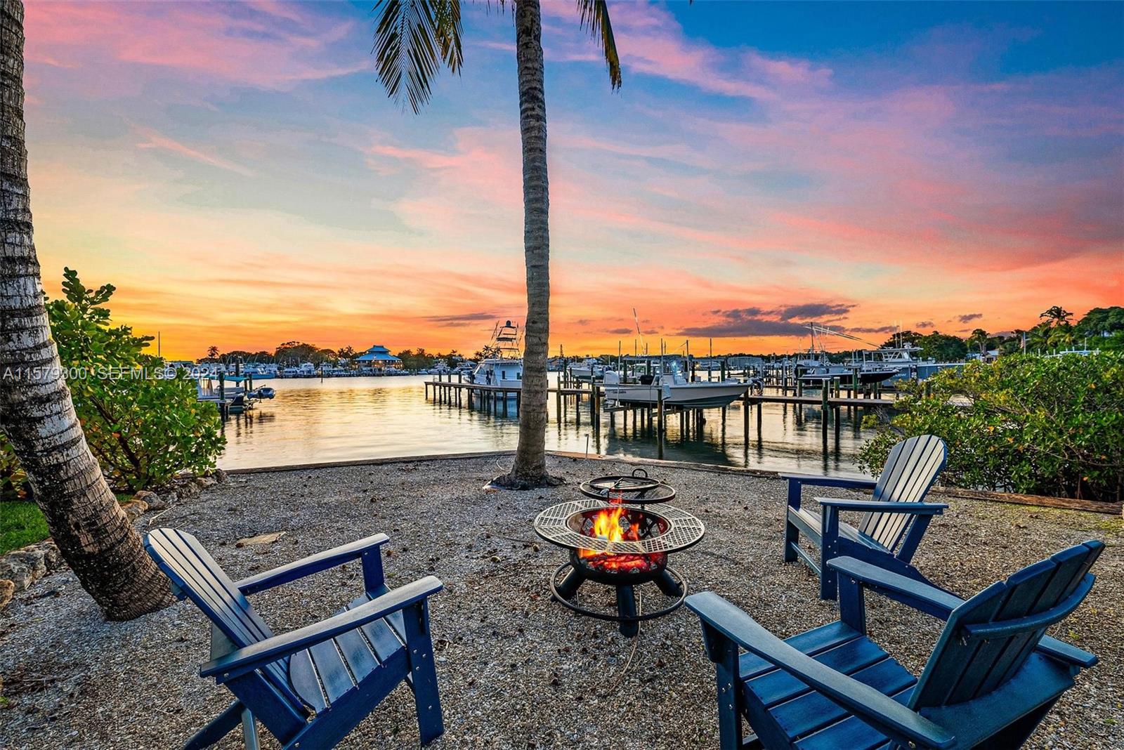 4643 Cheerio Way Stuart, FL 34997 - Photo 13 of 69 a view of a terrace with lawn chairs and a fire pit
