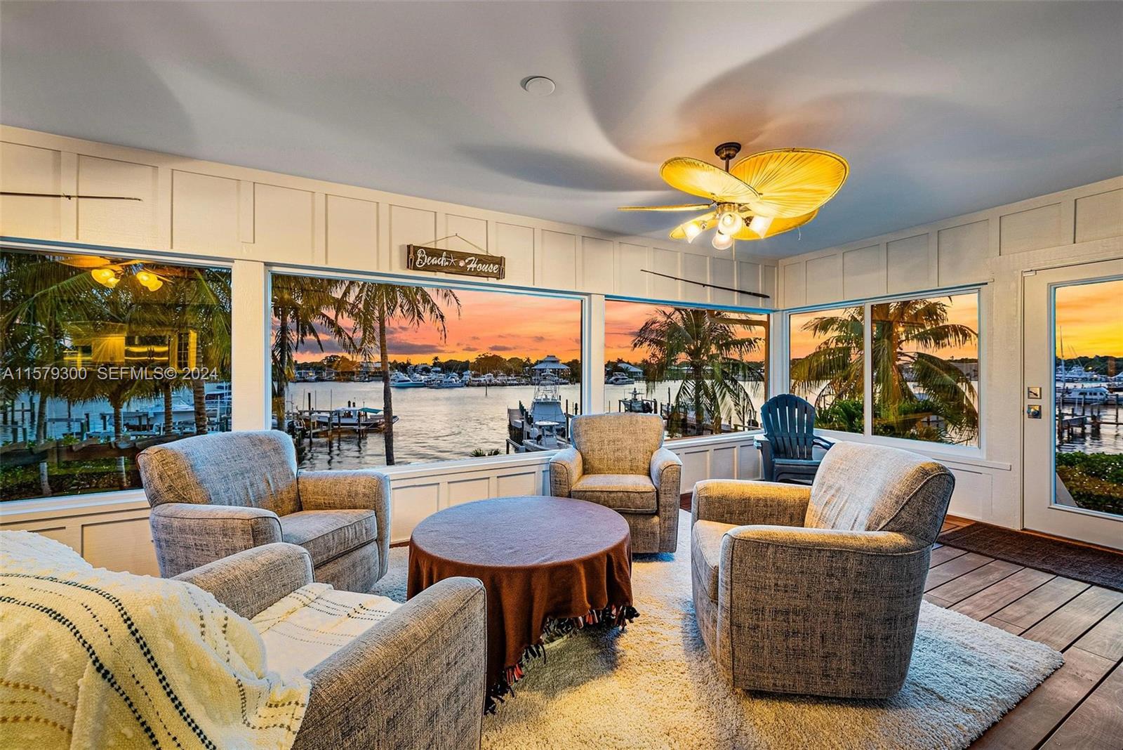 4643 Cheerio Way Stuart, FL 34997 - Photo 31 of 69 a living room with furniture a fireplace and a large window