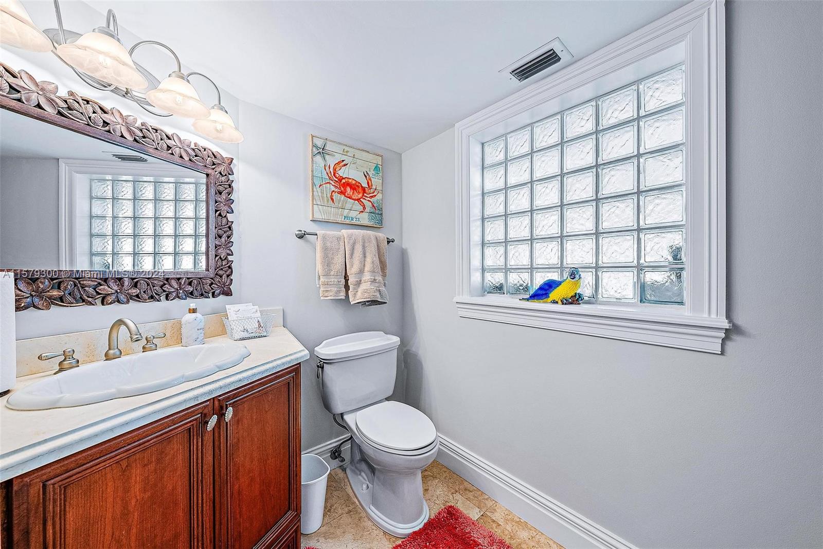 4643 Cheerio Way Stuart, FL 34997 - Photo 32 of 69 a bathroom with a sink a toilet and a window