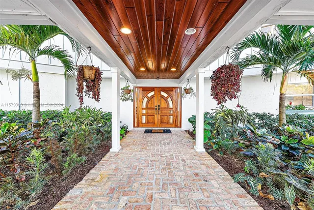 a bathroom with a granite countertop sink mirror vanity and toilet