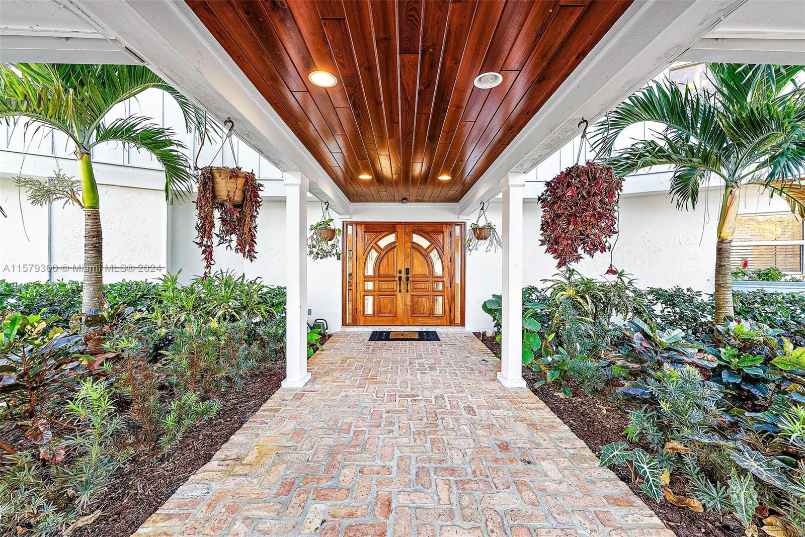 4643 Cheerio Way Stuart, FL 34997 - Photo 35 of 69 a view of entryway with a flower garden