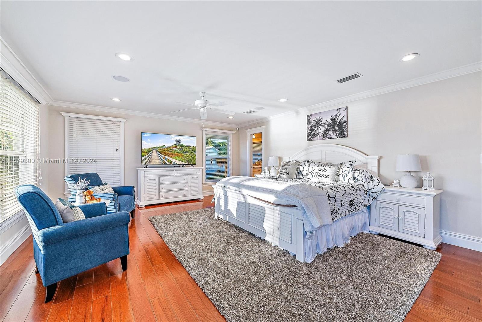 4643 Cheerio Way Stuart, FL 34997 - Photo 39 of 69 a spacious bedroom with a bed and a couch