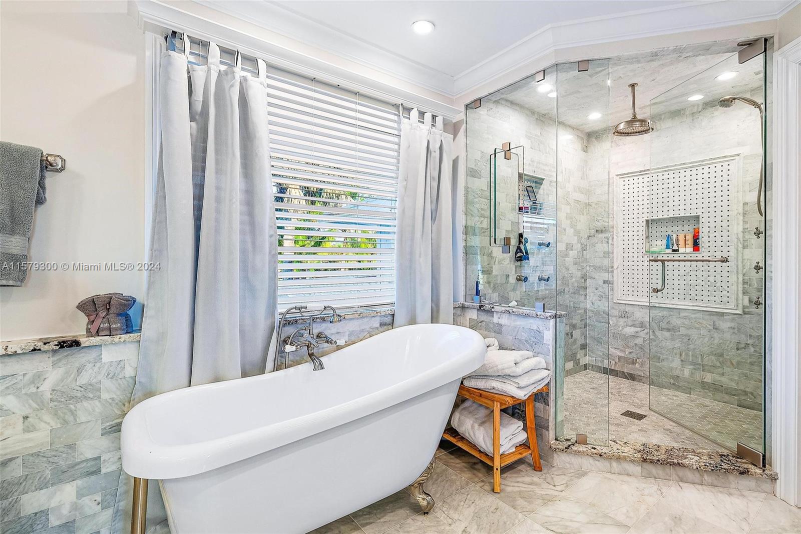 4643 Cheerio Way Stuart, FL 34997 - Photo 43 of 69 a bathroom with a tub shower and sink