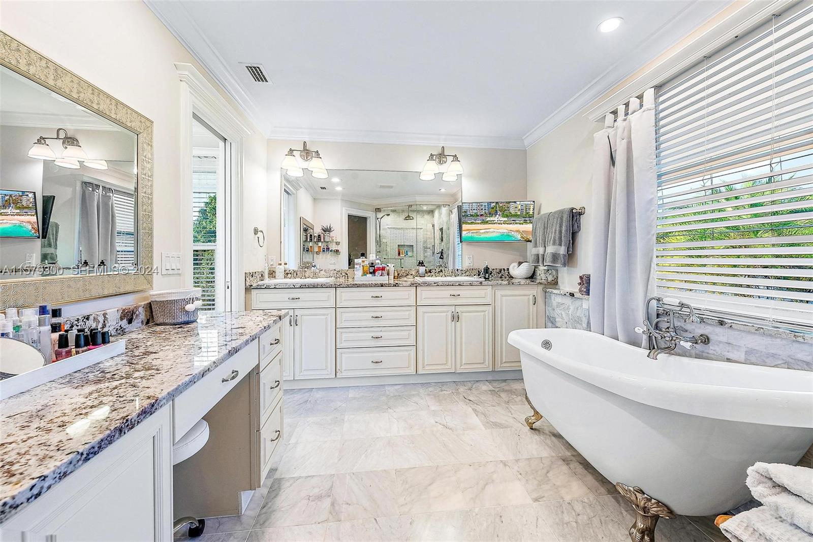 4643 Cheerio Way Stuart, FL 34997 - Photo 44 of 69 a bathroom with a granite countertop sink mirror and a bathtub