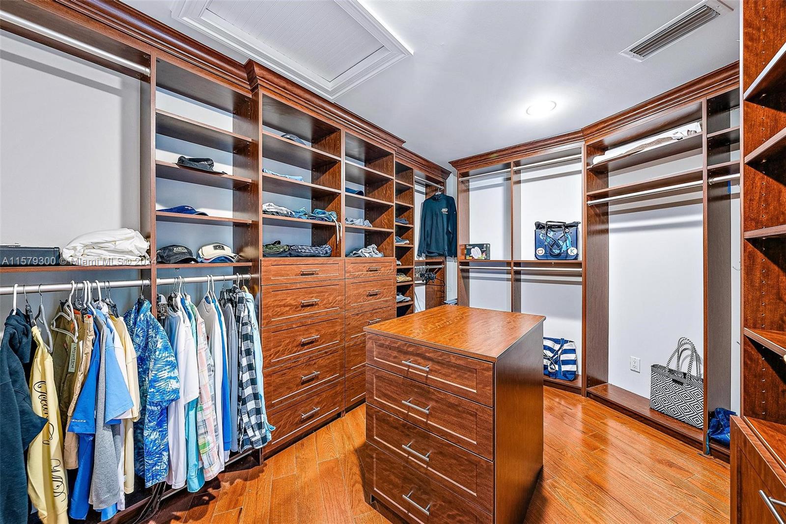 4643 Cheerio Way Stuart, FL 34997 - Photo 45 of 69 a view of walk in closet with clothes and shoes
