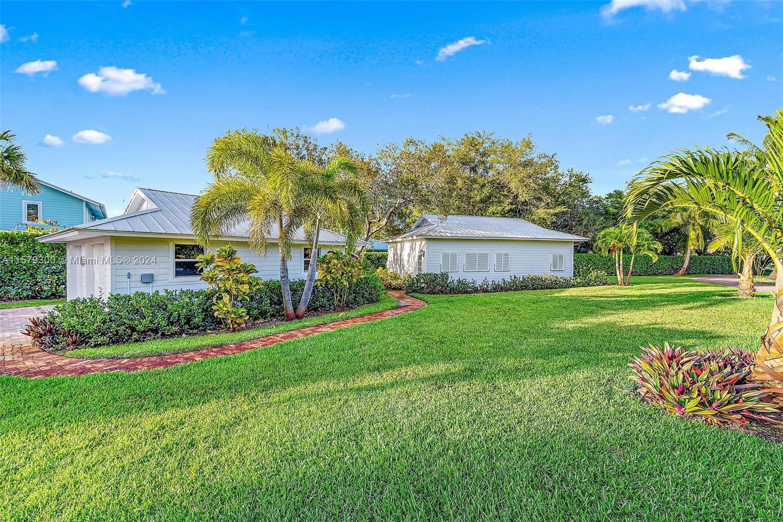 4643 Cheerio Way Stuart, FL 34997 - Photo 52 of 69 a front view of a house with garden