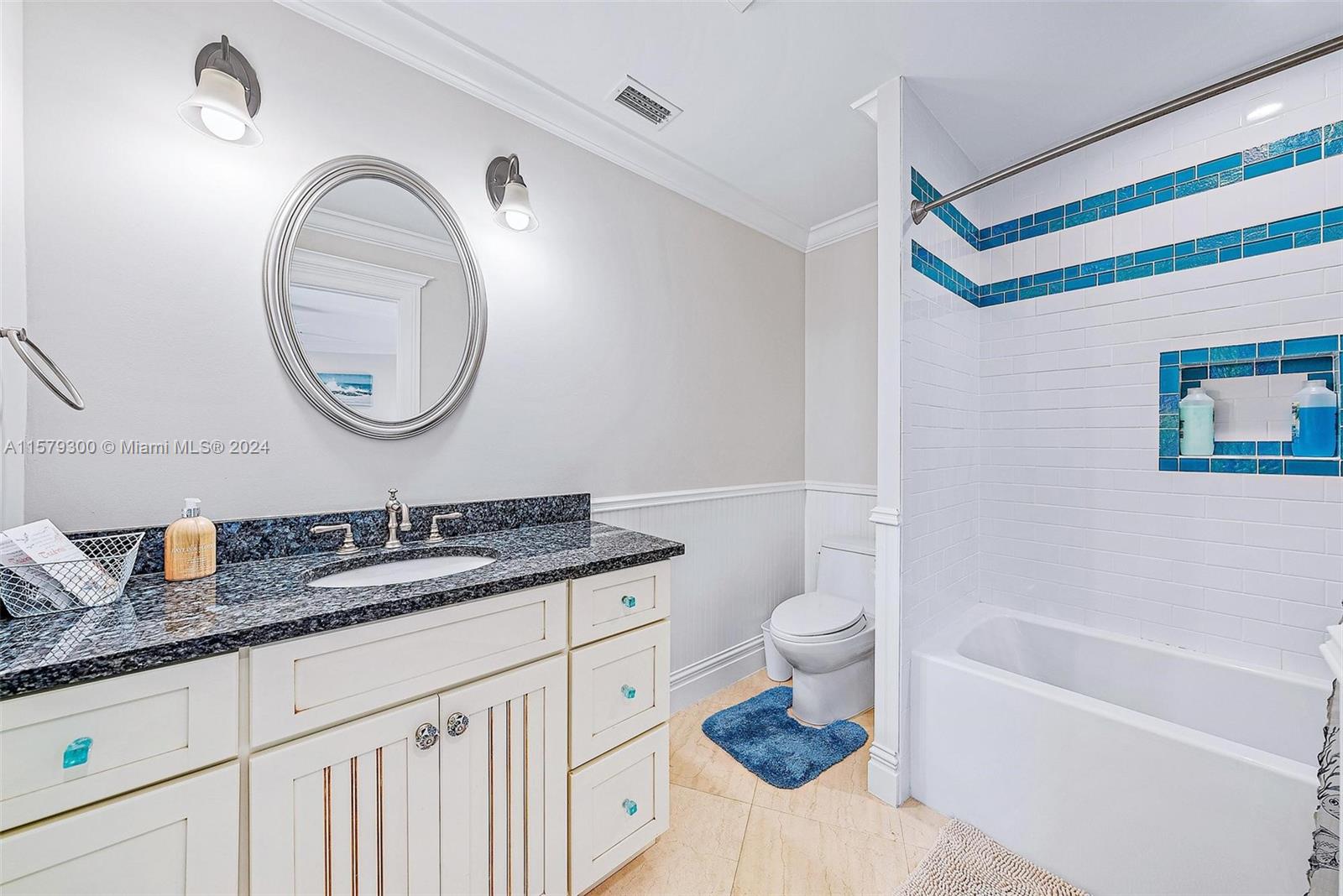 4643 Cheerio Way Stuart, FL 34997 - Photo 53 of 69 a bathroom with a granite countertop sink mirror vanity and toilet