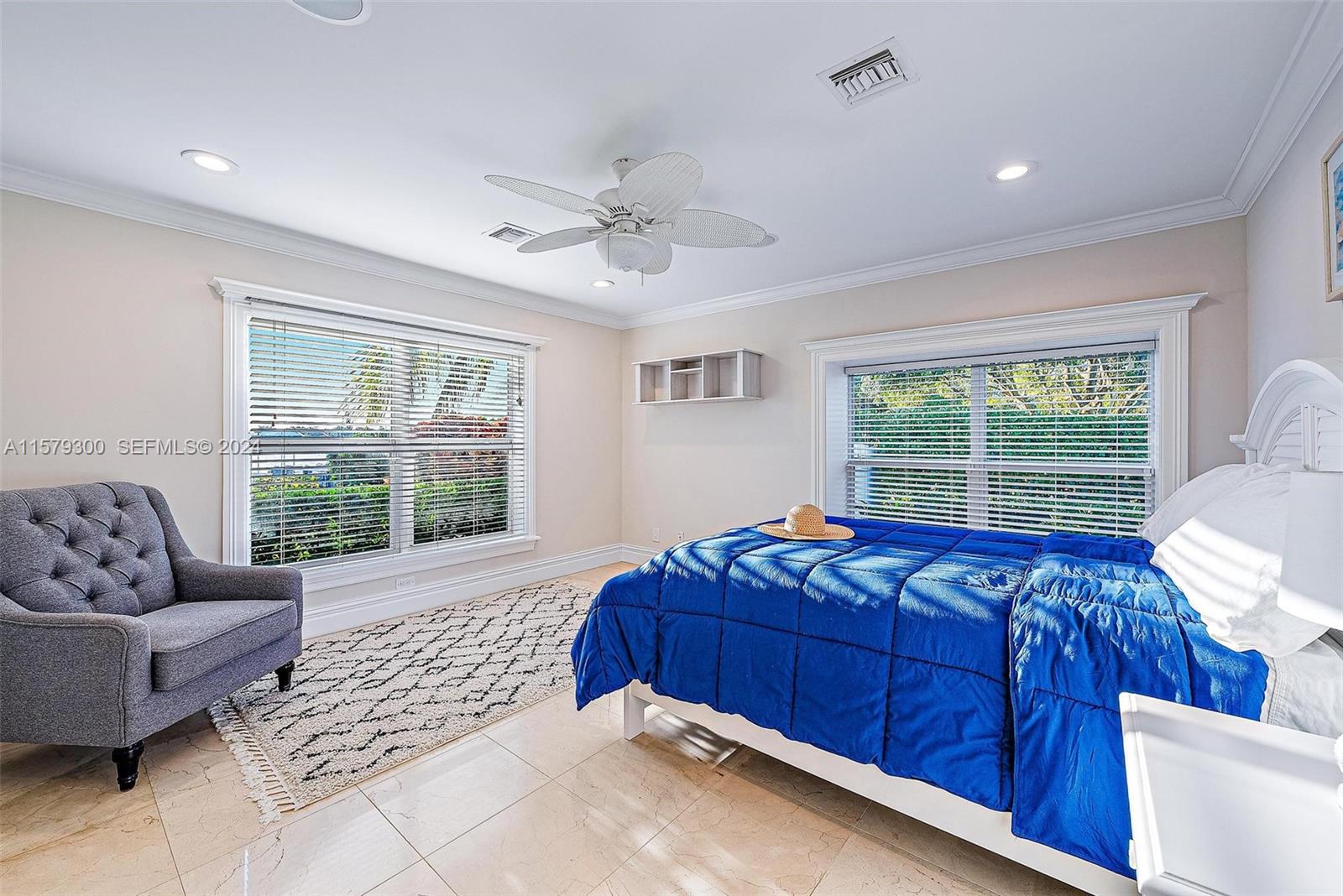 4643 Cheerio Way Stuart, FL 34997 - Photo 54 of 69 a bed sitting in a bedroom next to a window