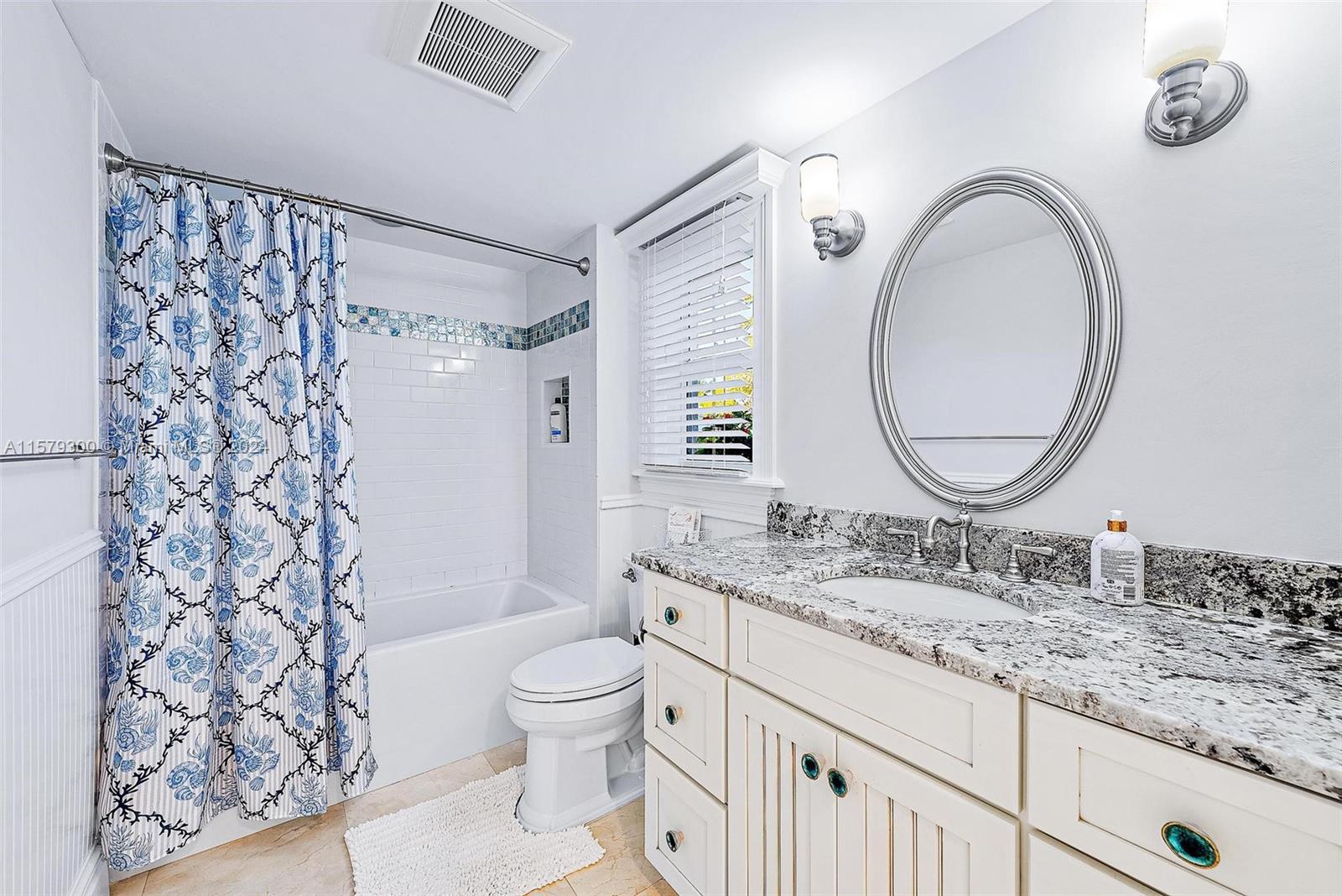 4643 Cheerio Way Stuart, FL 34997 - Photo 55 of 69 a bathroom with a granite countertop sink a toilet and a mirror