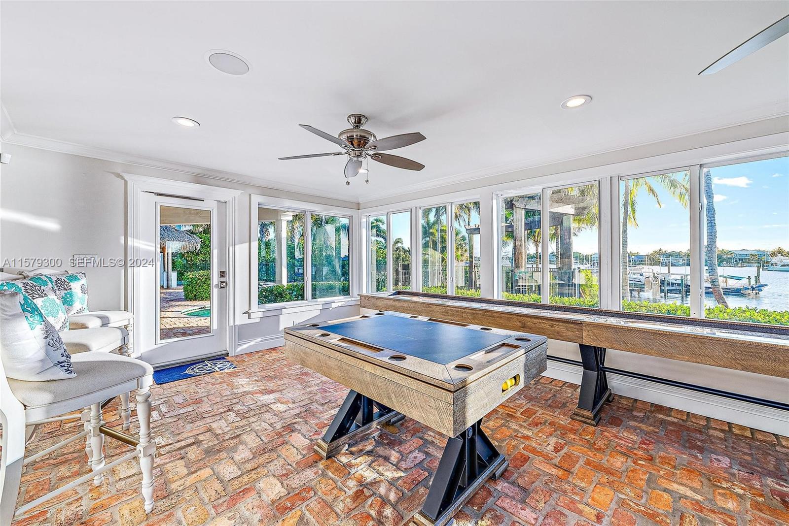 4643 Cheerio Way Stuart, FL 34997 - Photo 57 of 69 a living room with a large window and a table