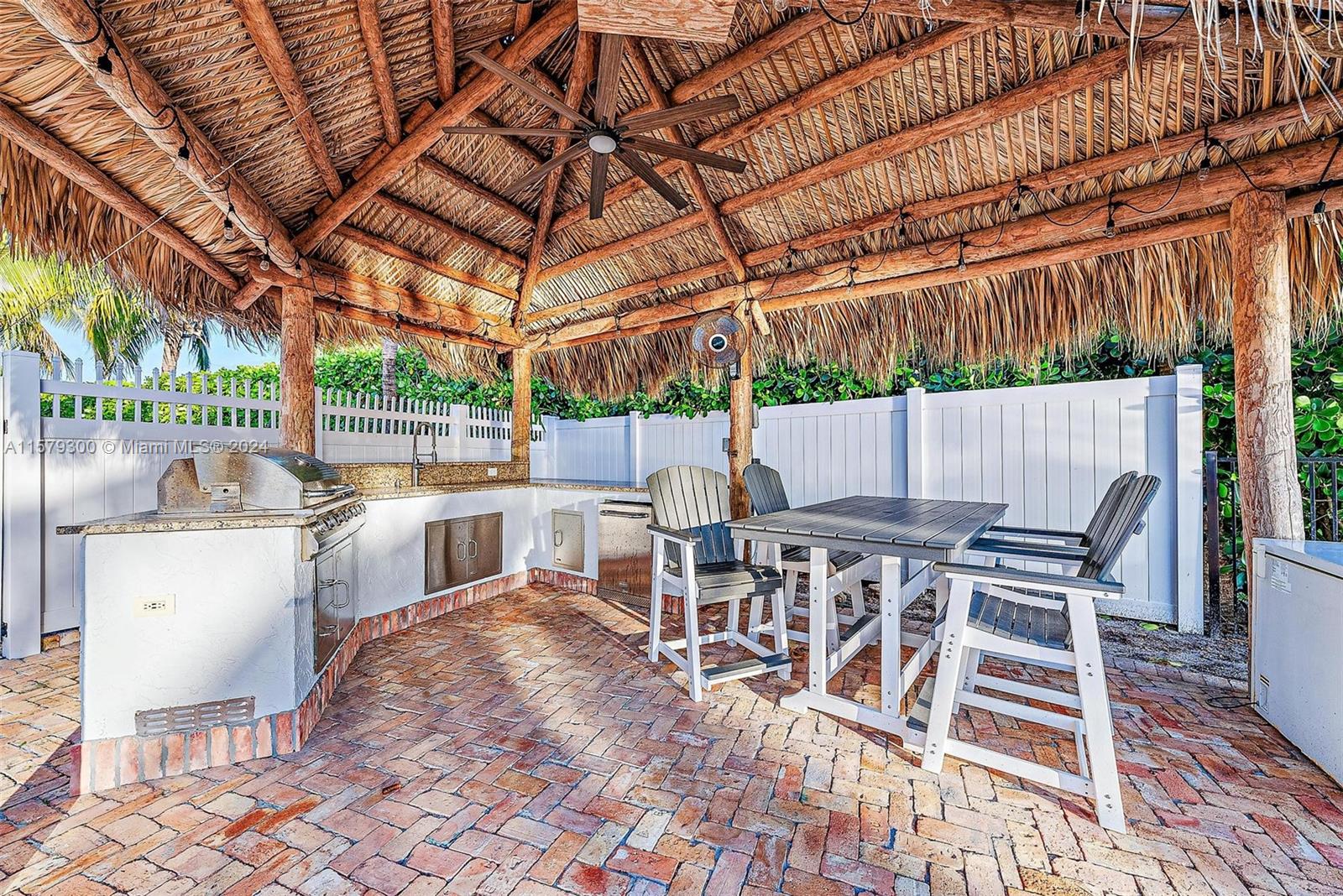 4643 Cheerio Way Stuart, FL 34997 - Photo 59 of 69 a view of a patio with a table and chairs