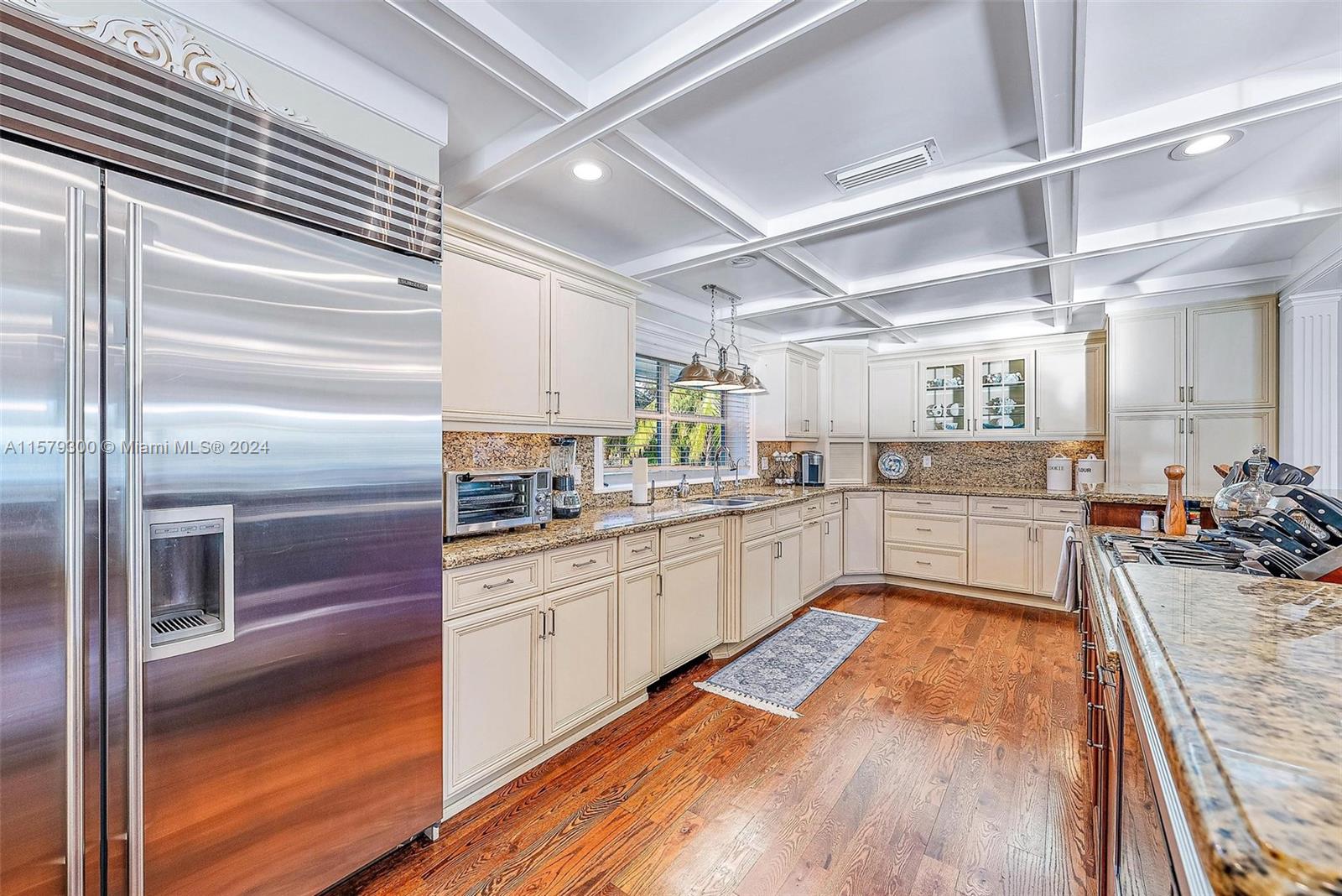4643 Cheerio Way Stuart, FL 34997 - Photo 6 of 69 a kitchen with stainless steel appliances granite countertop lots of counter top space and cabinets