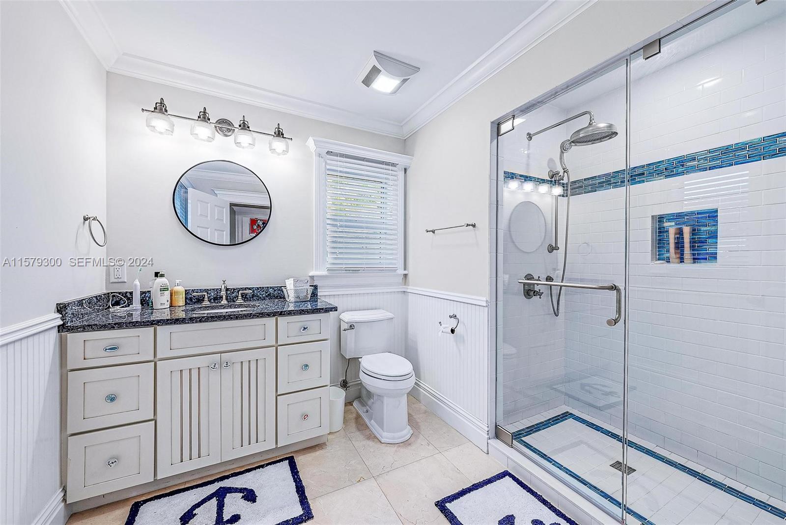4643 Cheerio Way Stuart, FL 34997 - Photo 66 of 69 a bathroom with a granite countertop toilet sink and a mirror