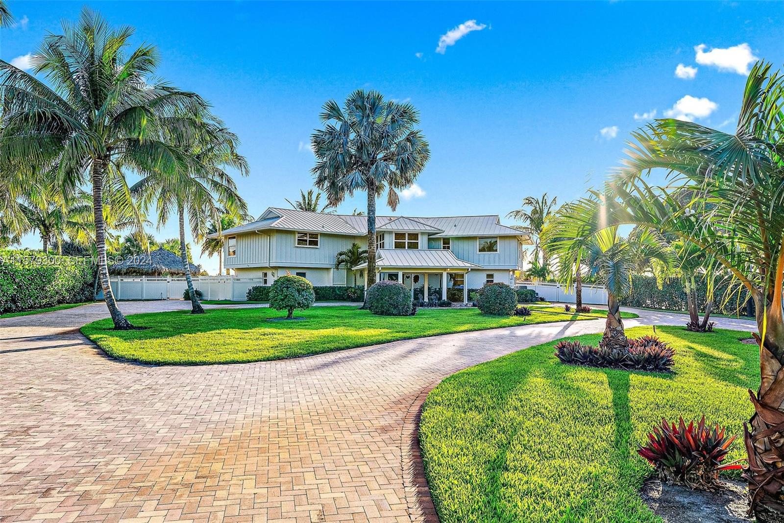 4643 Cheerio Way Stuart, FL 34997 - Photo 69 of 69 a front view of a house with a yard and trees