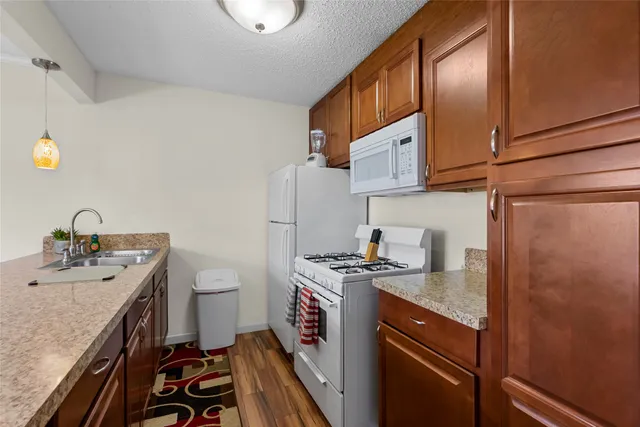a kitchen with a sink stove and cabinets