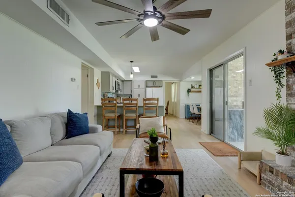 a living room with furniture and a chandelier