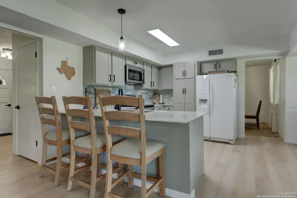a kitchen with a refrigerator sink and white stove