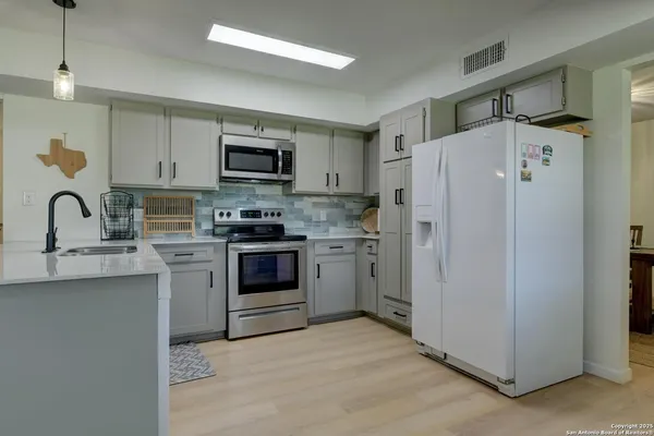 a kitchen with stainless steel appliances granite countertop a stove and a sink