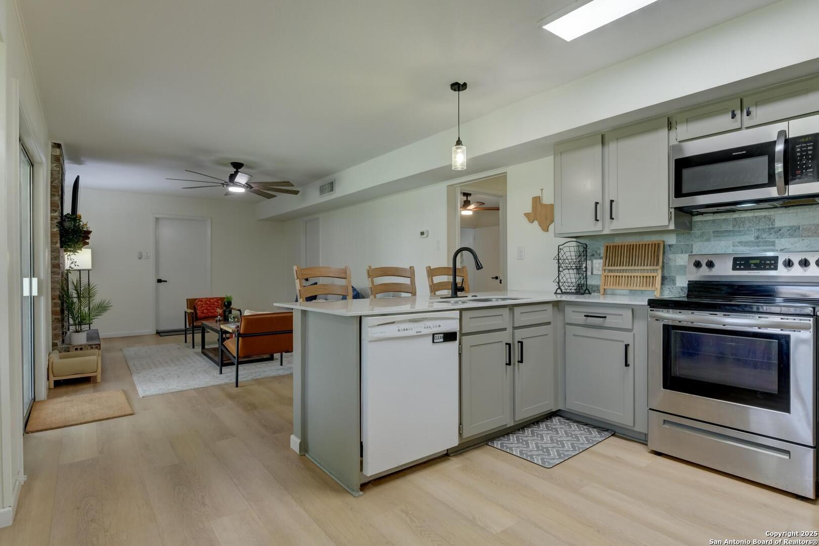 5018 Risada Street San Antonio, TX 78233 - Photo 16 of 39 a kitchen with stainless steel appliances granite countertop a stove and a sink