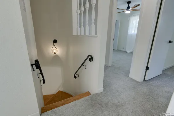 a bathroom with a granite countertop sink a mirror and a bathtub